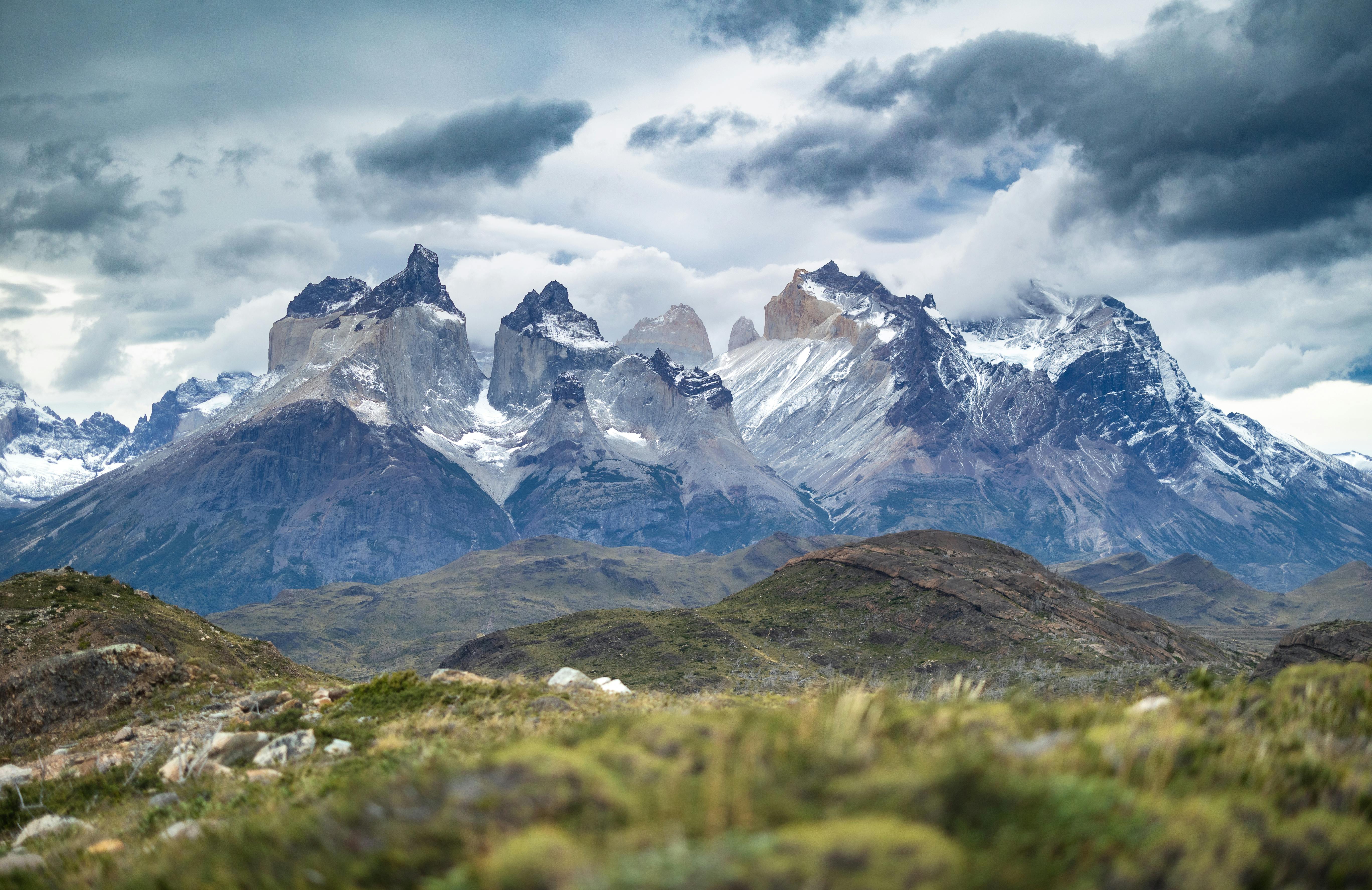 Ancient Inca ruins high in the Andes mountains of Peru, surrounded by lush green peaks.